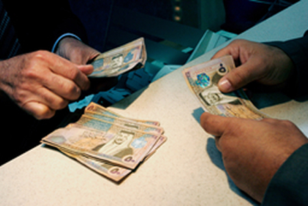 Counting money in a bank in Amman.